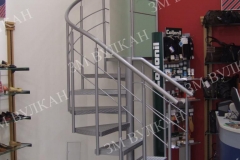 Металлическая радиусная лестница отлично вписывается в интерьер помещения оборудованного под обувной шоу-рум, как в данном случае